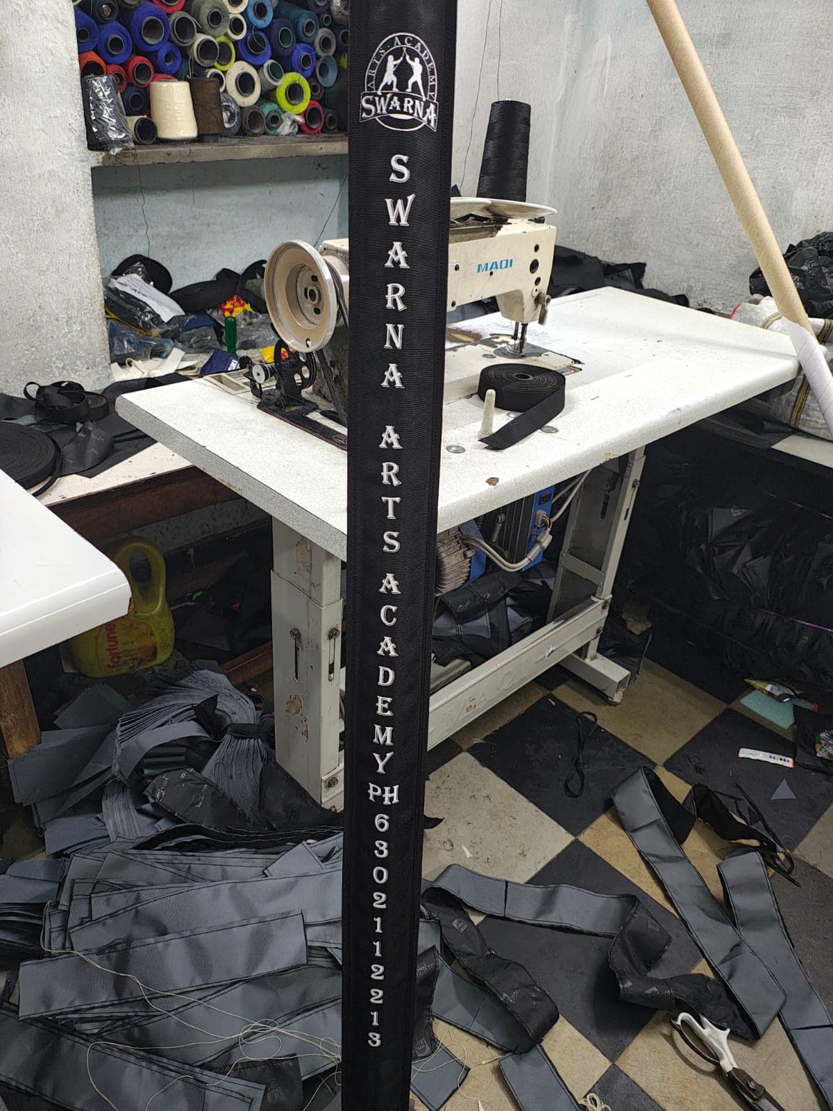 Custom branded webbing being stitched at the workshop