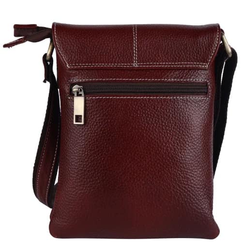 Dark burgundy leather sling bag with a flap, a zipped front pocket and an adjustable shoulder strap