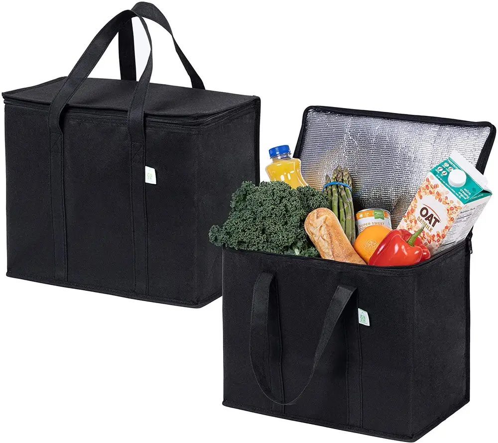 Two black insulated delivery totes, one closed and one open showing the foil-lined interior packed with groceries